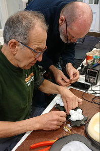 Two men fixing a radio at Canton Library